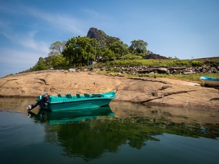 Beautiful Lake Mountain Landscape with an isolated boat in Senanayake Samudraya Galoya National Park Inginiyagala, Ampara, Sri Lanka