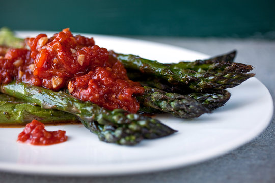 Roasted asparagus with tomato and coriander sauce