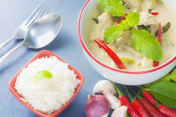Green chicken curry with raw spicy ingredient and rice with spoon and fork, Thai traditional food