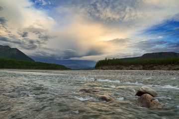 Rocky river in the mountains and beautiful sky. The River Cibagalakh. Yakutia. Russia.