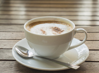 Coffee cup over brown plank wood table
