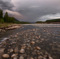 Rocky river in the mountains and beautiful sky. The River Cibagalakh. Yakutia. Russia.