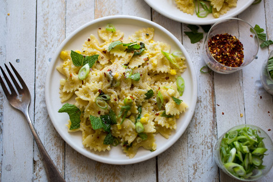 Creamy corn pasta, on white plate, overhead vew