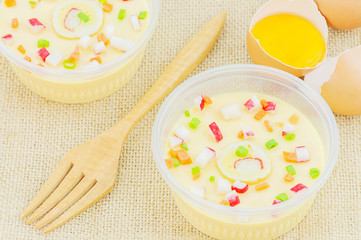 Thai steamed egg with fresh beaten egg and fork decoration on sack background