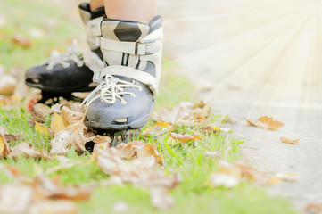 Closeup of boy is standing with roller blade, selective focused.