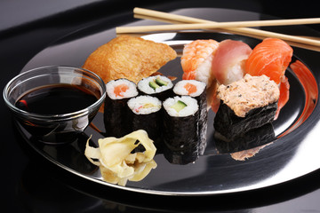 close up of sashimi sushi set with chopsticks and soy - sushi roll with salmon and sushi roll, delicious maki and nigiri
