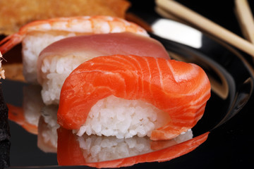 close up of sashimi sushi set with chopsticks and soy - sushi roll with salmon and sushi roll,...
