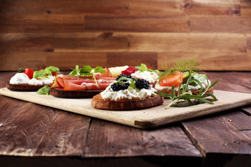 Bread Brushetta or authentic traditional spanish tapas set for lunch table. Sharing antipasti on...
