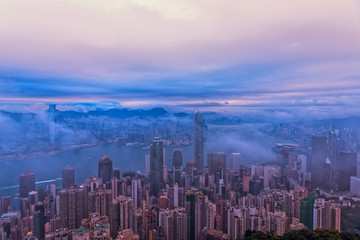 Misty morning view of Victoria harbor of Hong Kong city
