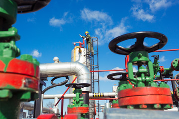 Oil and gas worker inside large petrochemical oil refinery