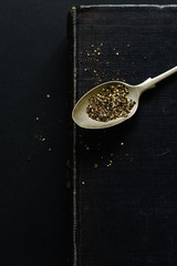 Teaspoon of Black Pepper on Vintage Cookbook 