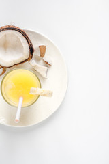 cocktail with coconut on white background top view