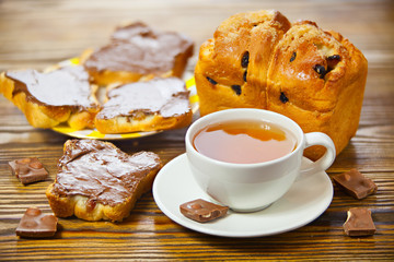 delicious tea with bread and chocolate paste on wooden