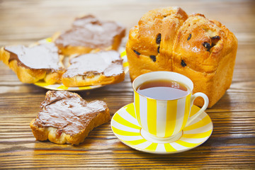 delicious tea with bread and chocolate paste on wooden