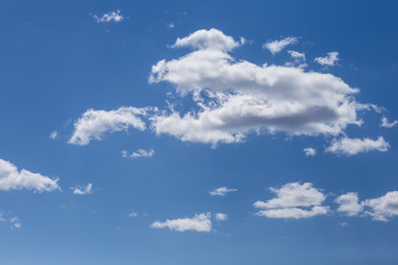 the clouds drifting across the blue sky