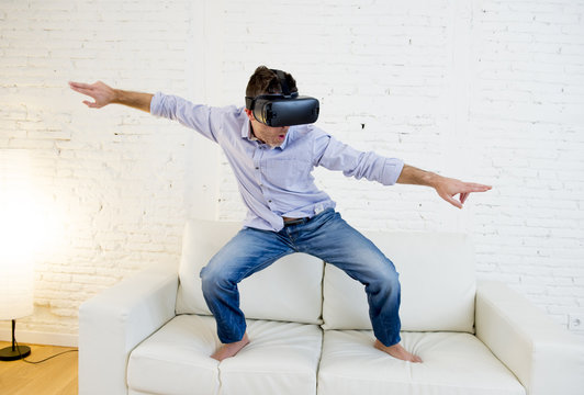 happy man at home living room sofa couch excited using 3d goggles virtual reality surfing
