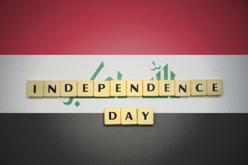 letters with text independence day on the national flag of iraq.