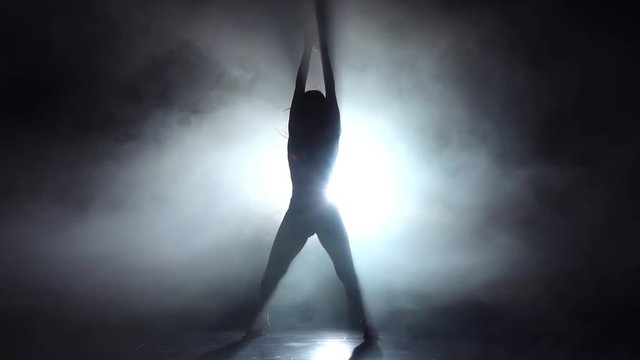 Sexy girl dancing in smoky studio twerk dance. Slow motion
