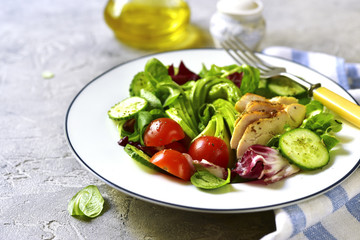 Fresh green salad with grilled chicken.