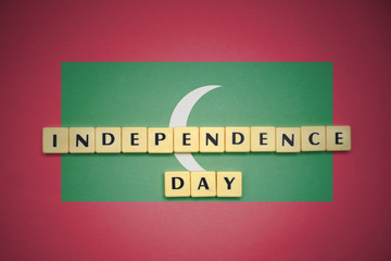 letters with text independence day on the national flag of maldives.