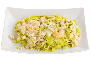 delicious green tagliatelle isolated on white