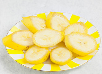 delicious ripe banana on plate on white table