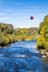 Hot air balloon over river in Colorado © DCrane Photography