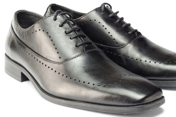 Classic black leather men's shoes isolated on white background.