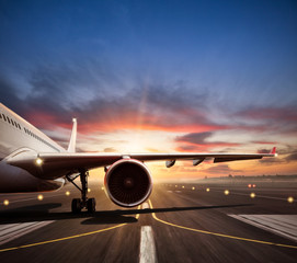 Close-up of airplane on runway in sunset light