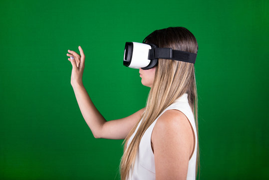 female model wearing virtual reality headset over green background