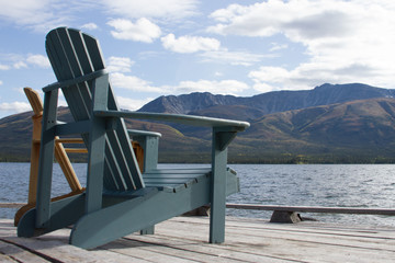 Two wooden chairs on decking,lakeside