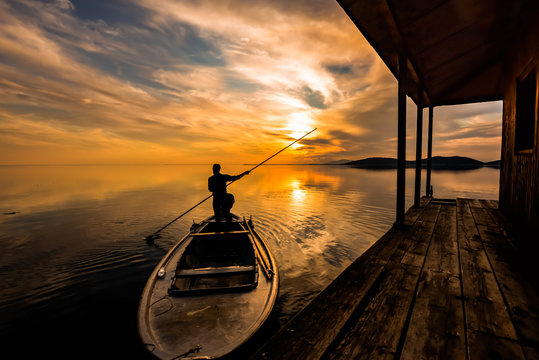 Person on boat at sunset
