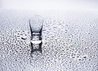 Glass on the table with water drops