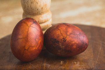Easter eggs on wooden background. Painted brown with spots and cracks