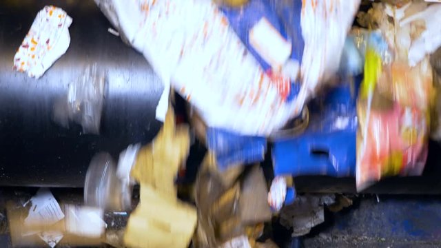 Trash on a conveyor at a recycling plant. No people. 4K.