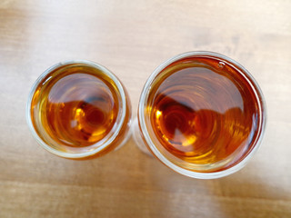 Glasses with cognac on the background of the wooden table