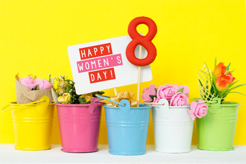 lollipop shape figure eight 8, note for text, flowers in colored buckets. Happy International Women’s Day celebrate on March 8, congratulatory CARD