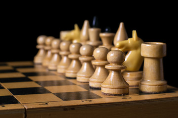 a game of chess, white figures stand on the positions of, isolated black background