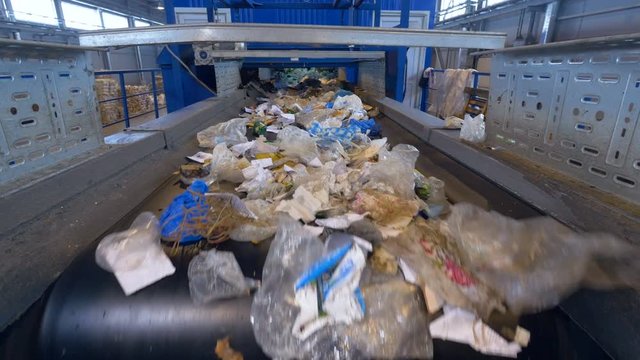 Garbage sorting conveyor on a waste recycling plant. 4K.