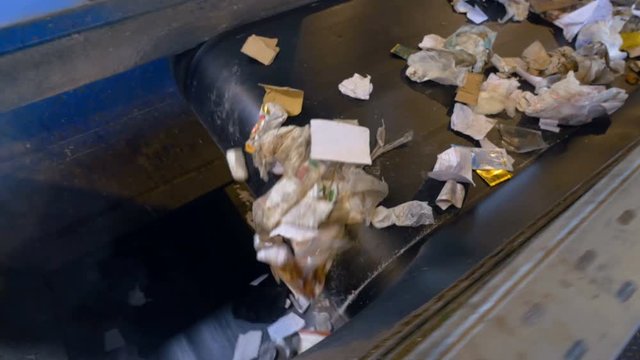 Garbage, trash, rubbish conveyor on a waste recycling plant. 4K