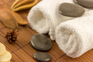 Spa towels and stones on mat