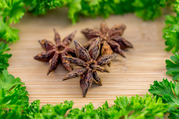 Star anise and Parsley on wood