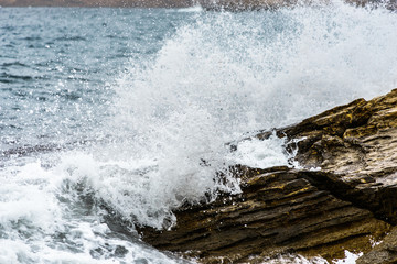 waves crushing into a rocky sea coast