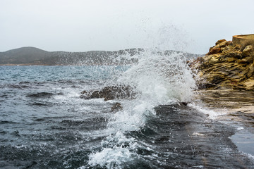 waves crushing into a rocky sea coast