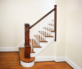 Interior of home foyer,  staircase, and hardwood floor.
