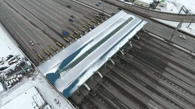 Wide multi line roadway with toll boths of the Western High Speed Diameter (WHSD) highway, St. Petersburg, Russia. Top view at winter season