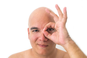 Fototapeta premium Face of a bald man in white background. With a hand on one eye.
