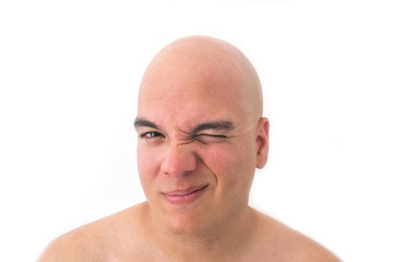 Face of a bald man in white background. Winking the eye.