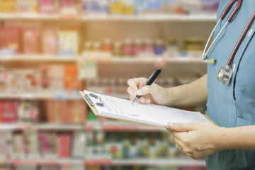 female doctor,surgeon,nurse,pharmacy with stethoscope on hospital holding clipboard,writing a prescription,Medical Exam,Healthcare and medical concept,test results,patient registration,selective focus