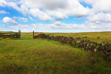 Open red gate of stone wall corral at South Point of Big Island, Hawaii